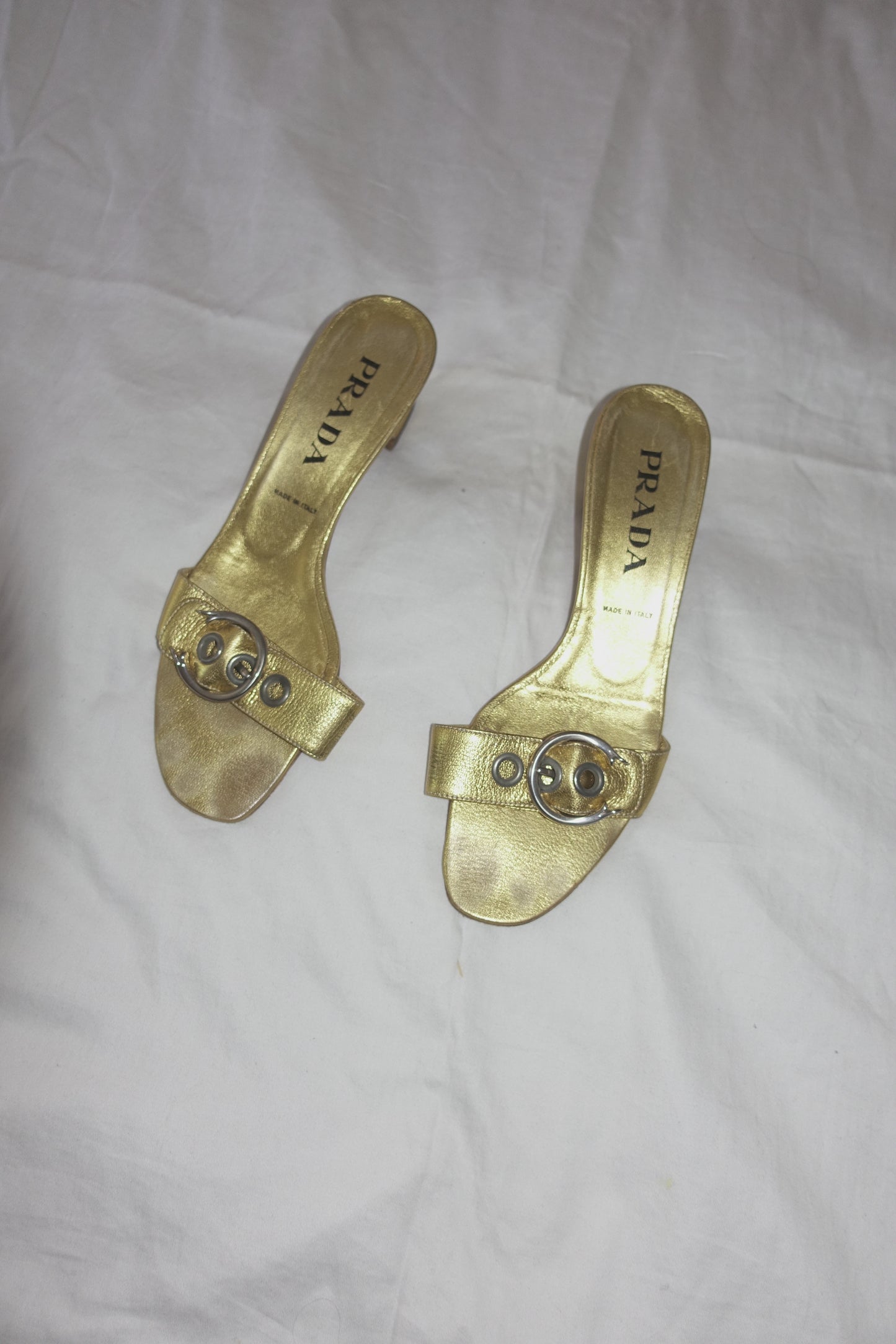 Prada gold buckle mules