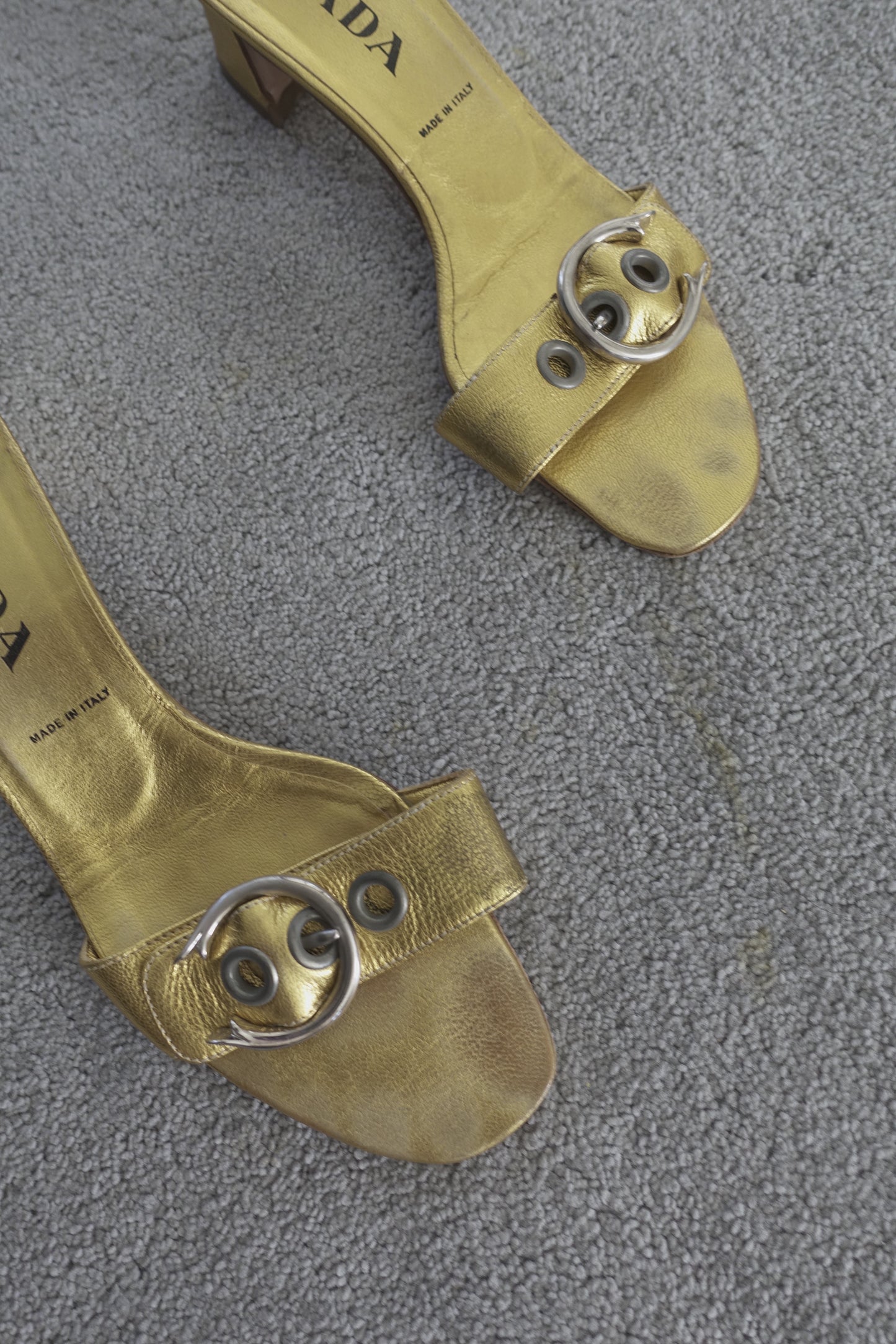 Prada gold buckle mules